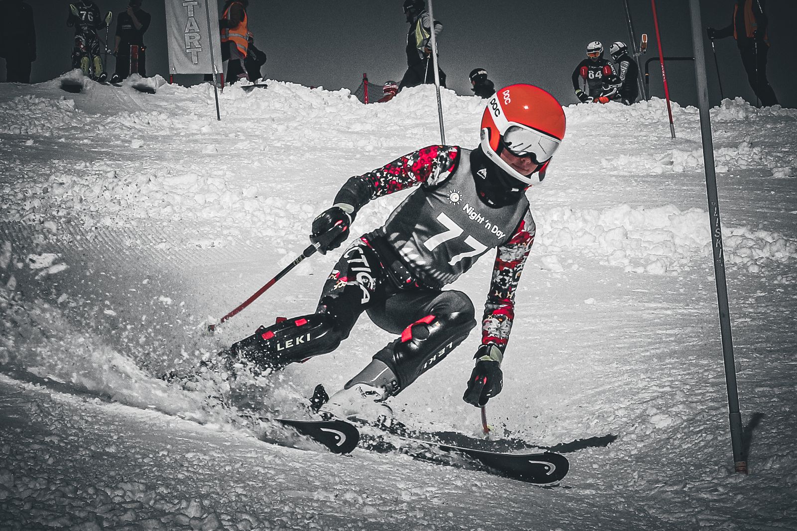 Black and white shot of Isla driving through a slalom gate